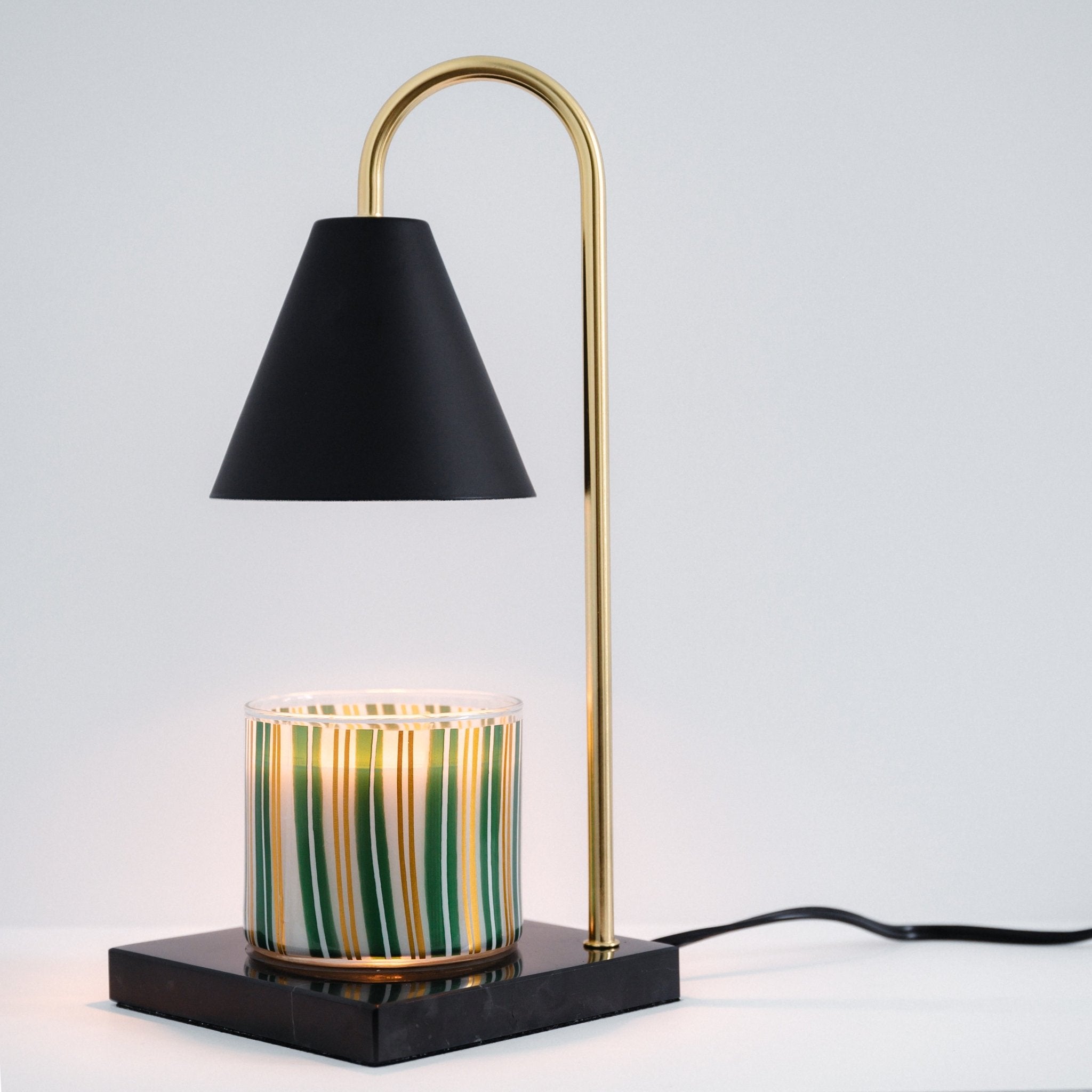 Black marble candle warmer with a designer jar candle on the base, showing the dimmer and timer